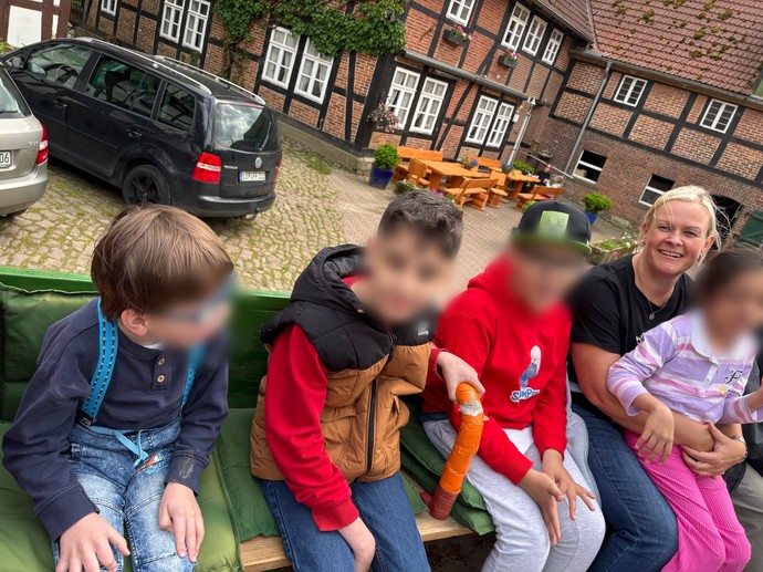 Vier SchülerInnen sitzen mit einer Lehrerin auf dem Trecker.
