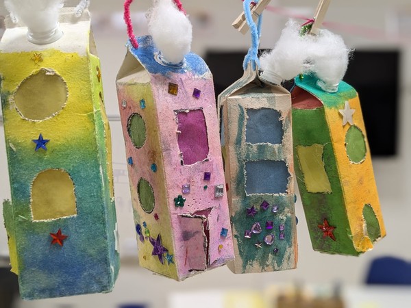 Vier eckige Laternen, die aussehen wie bunte Häuser