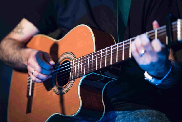 Eine Person spielt auf einer Gitarre.